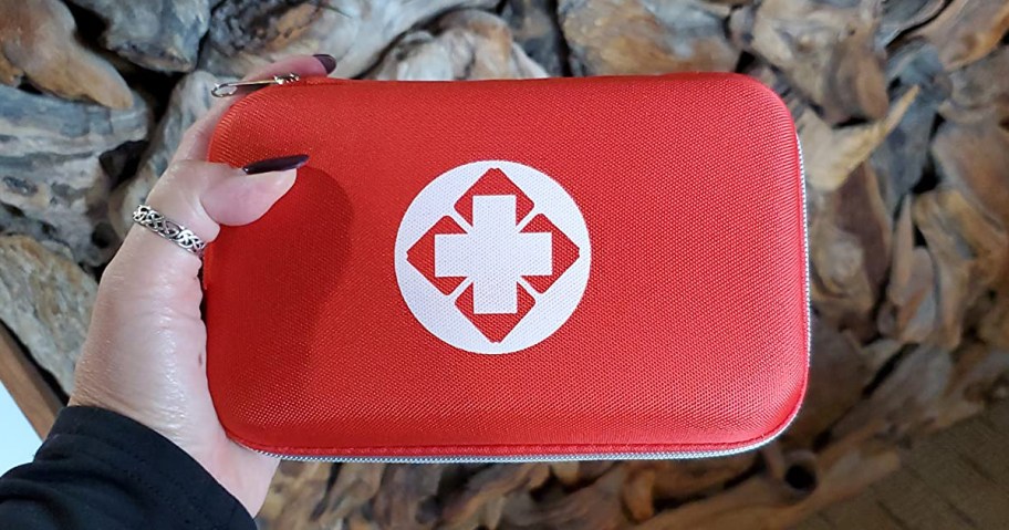 hand holding a first aid kit