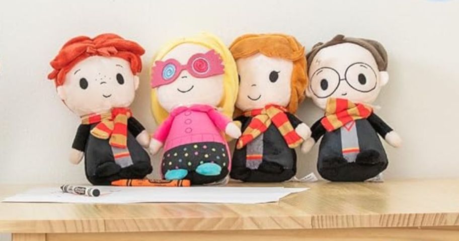 Ron Weasley, Hermione Granger, Luna Lovegood, & Harry Potter Plush Set on table