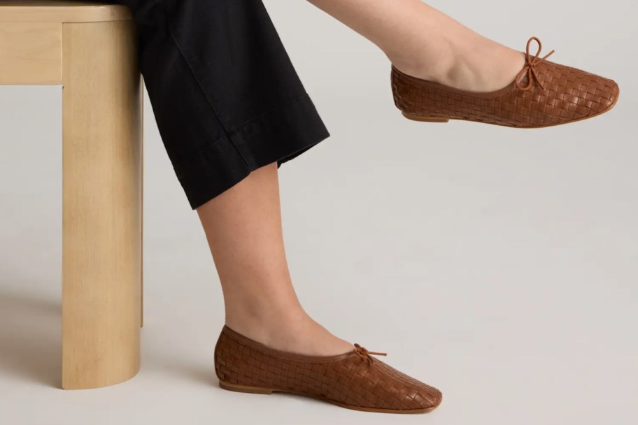 feet in handwoven ballet flats