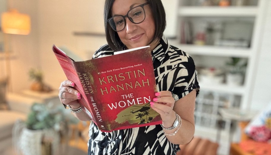 woman holding the women book while reading