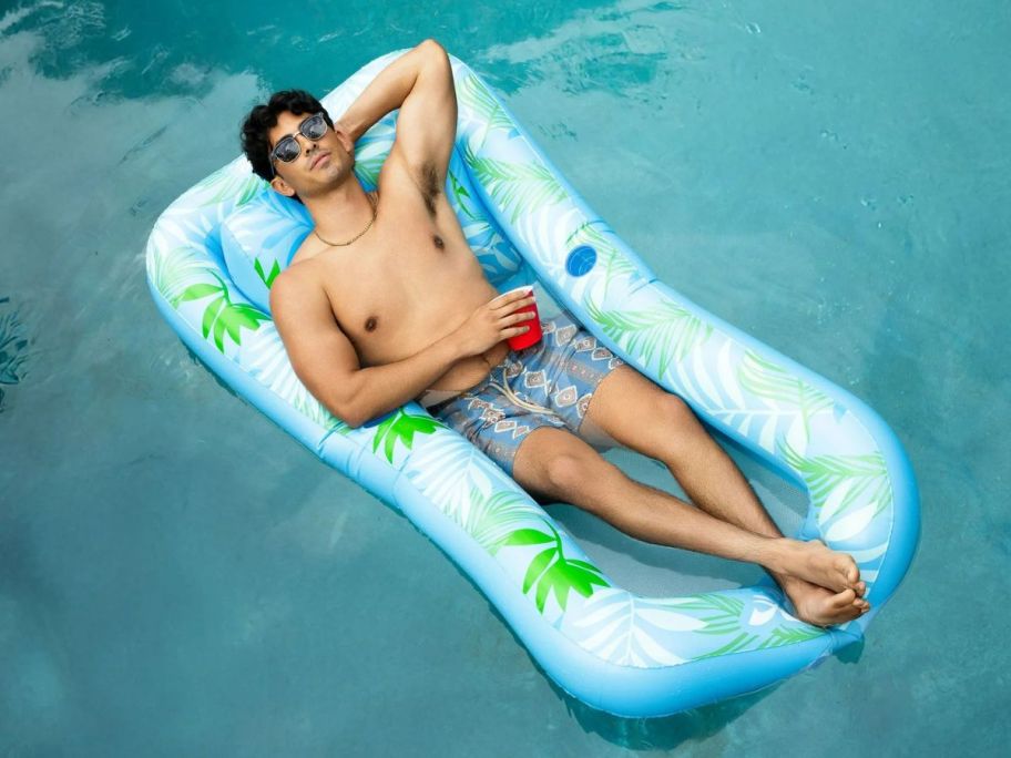 man laying in a Hobie Inflatable Day Bed Float w/ Backrest in water