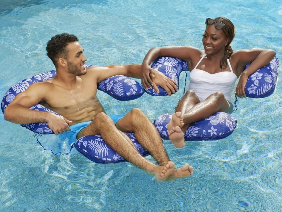 A manin a woman istting in Aqua-Leisure Inflatable 3-in-1 Lounge Chairs in a pool