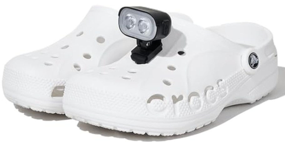 black headlight accessory on white clogs shoes