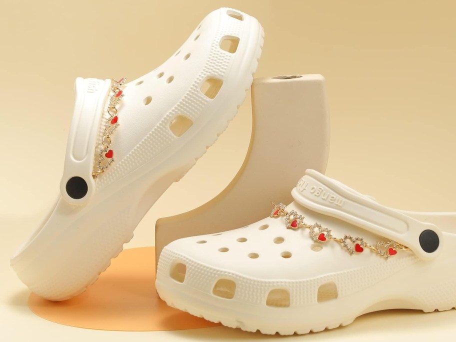 gold heart chains on white clog shoes