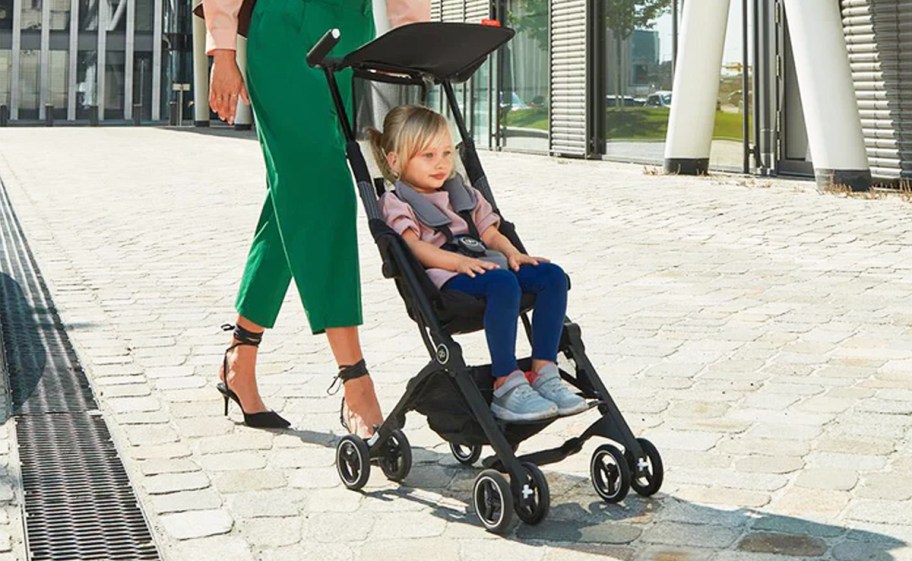 woman pushing child in a stroller