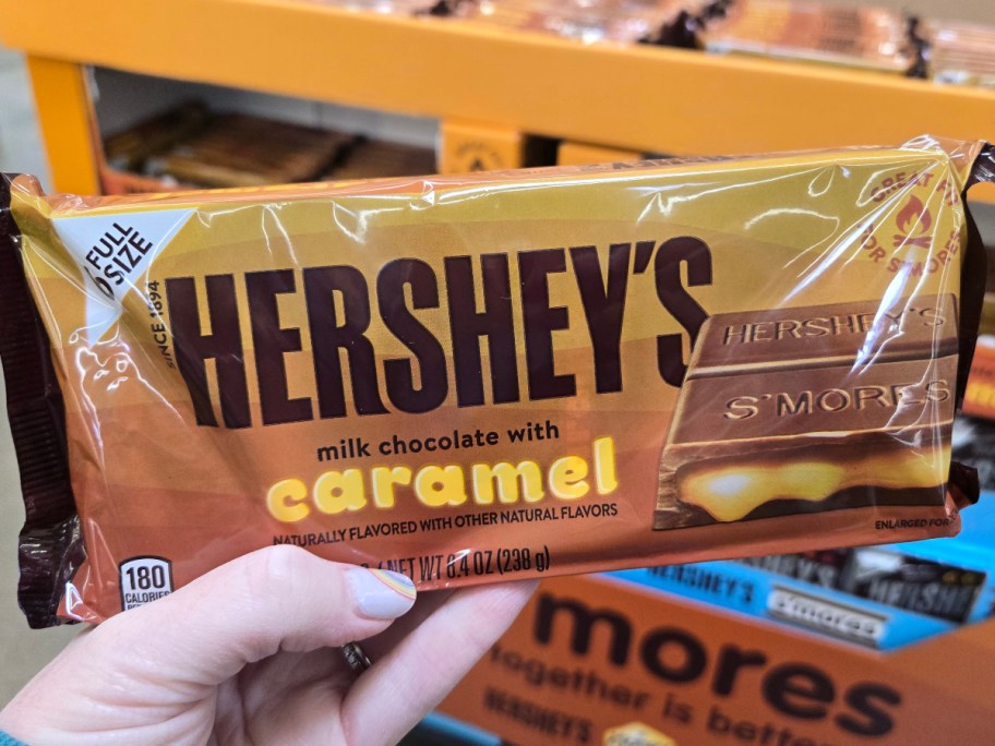 holding a caramel hershey bar
