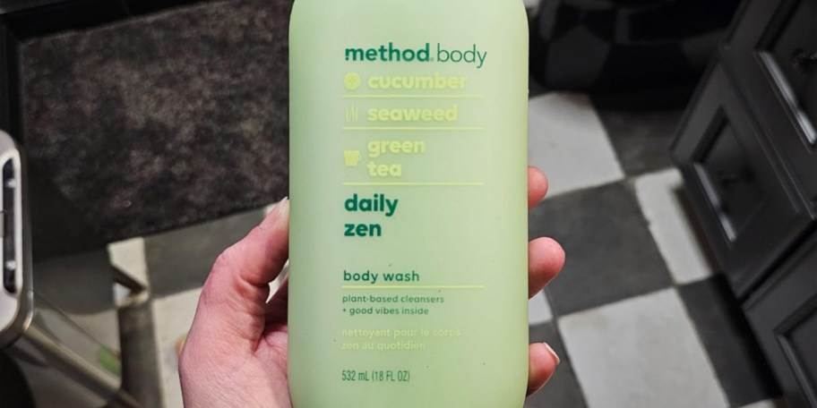hand holding method body wash bottle 