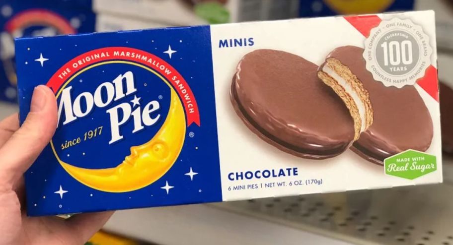 hand holding a box of moon pie