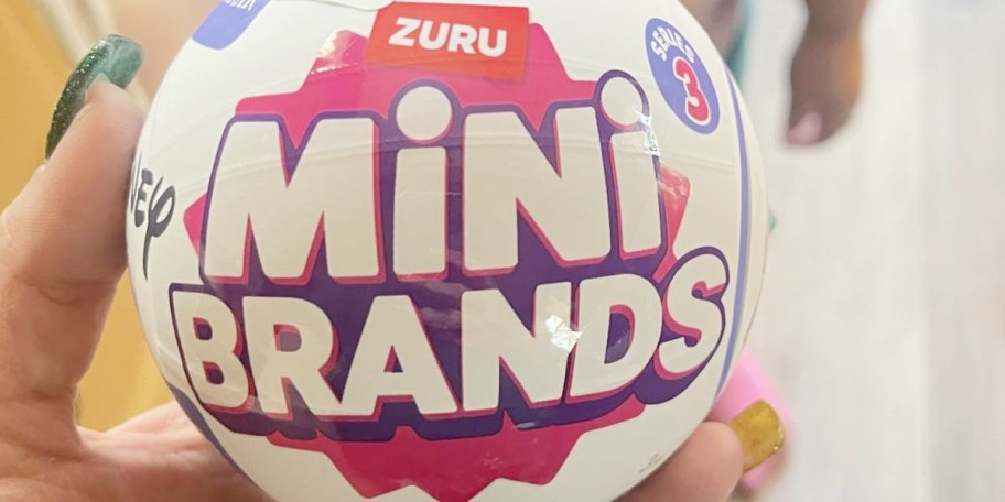 hand holding zuru mini brands capsule