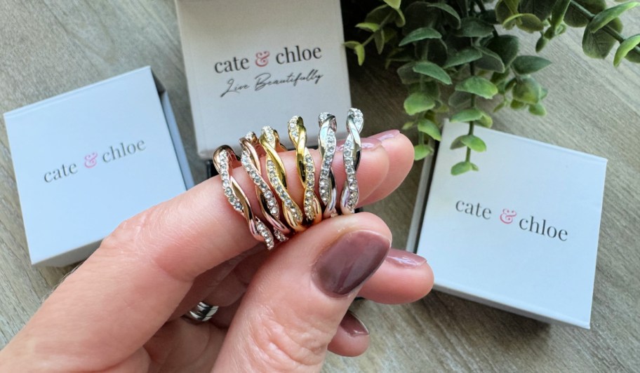Cate & Chloe Earrings on a woman's finger