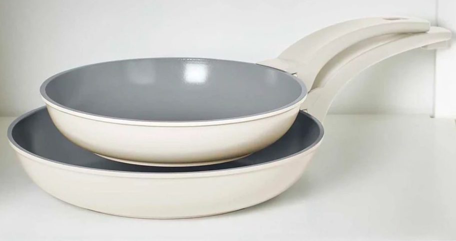 A Dash SmartStore Frying Pan Set ne4sted in a cabinet
