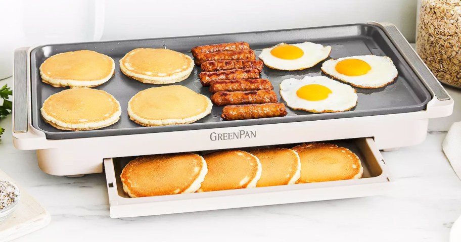 pancakes, sausage, and eggs on top of electric skillet with more pancakes inside warming drawer
