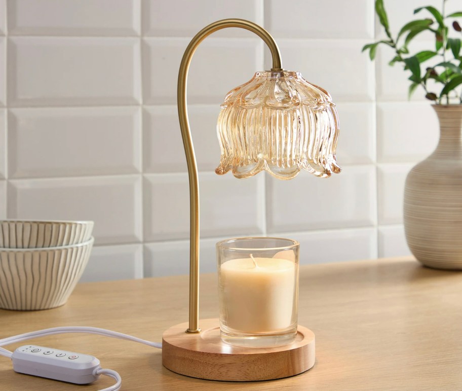 amber glass lamp on counter with candle
