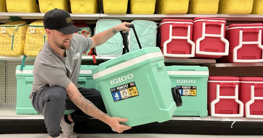 man holding rolling igloo cooler in store