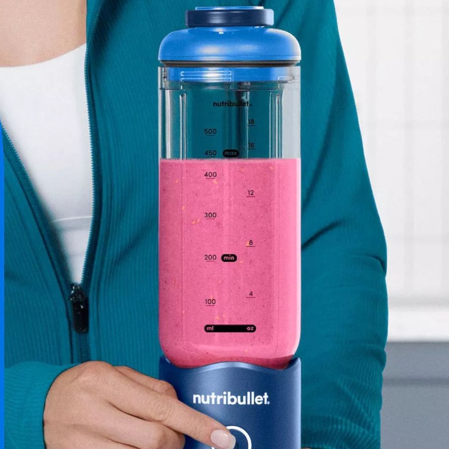 hand pressing NutriBullet Flex Portable Blender 22oz. Blender
