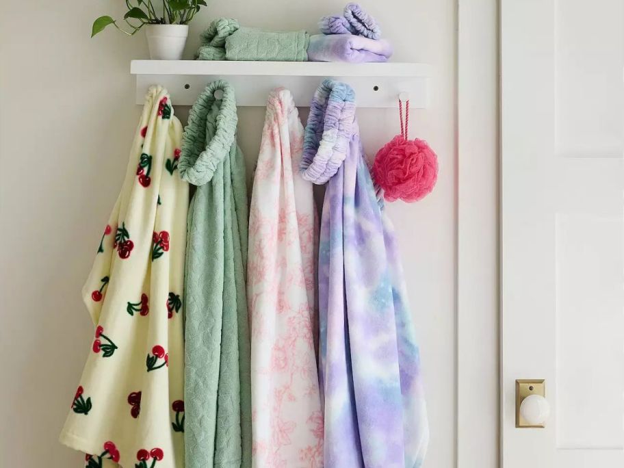 4 Bath Wrap Sets hanging in a bathroom