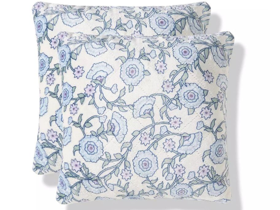 2 blue and white pillows with flowers