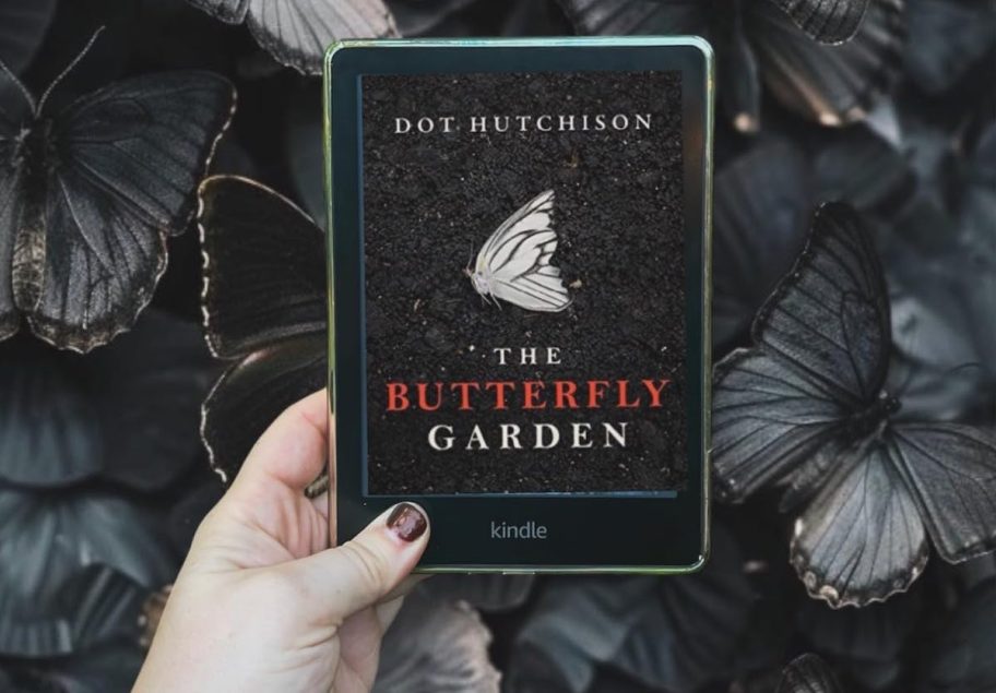 hand holding the butterfly garden audible book