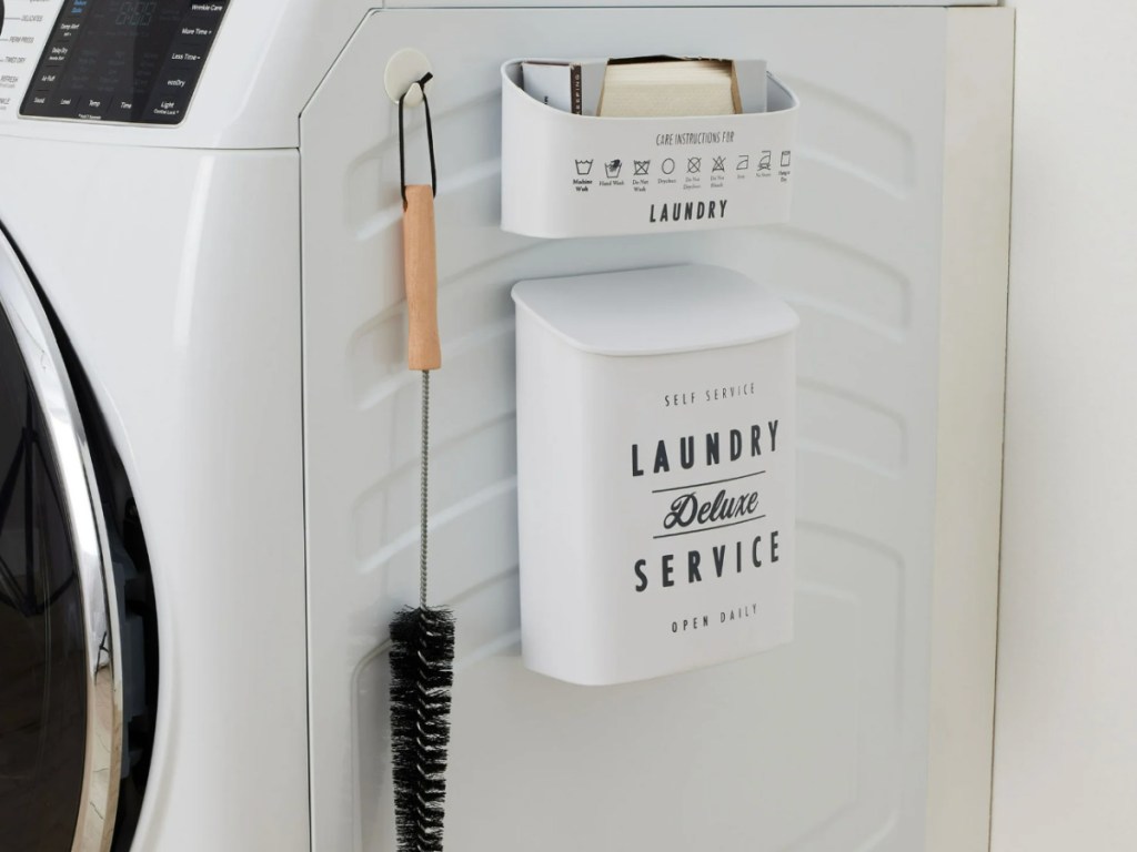 White metal laundry, lint set attached to the side of a washing machine