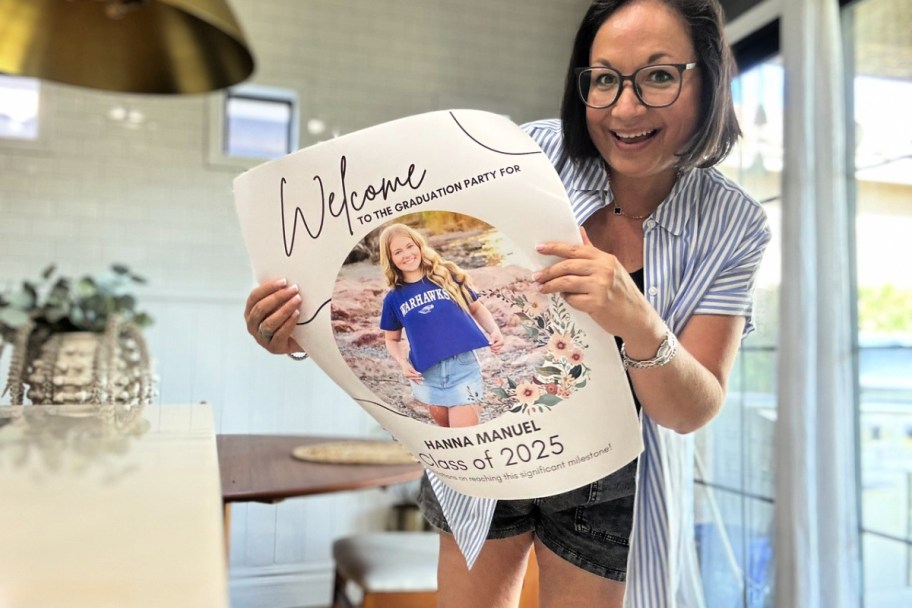 woman showing off a walgreens photo poster