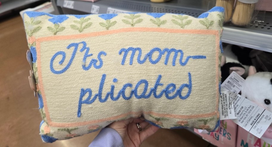 hand holding its mom plicated pillow