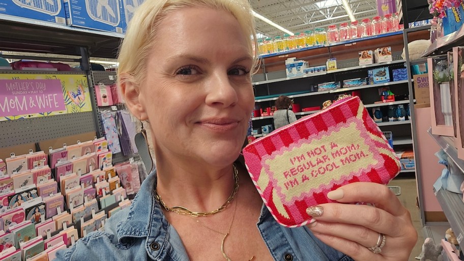 woman holding i'm not a regular mom I'm a cool mom wristlet in card aisle