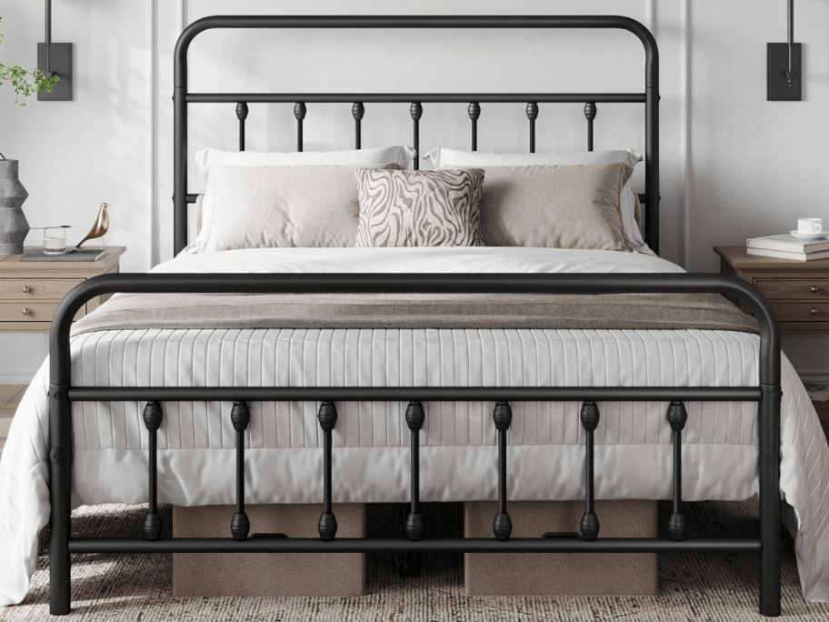 black fullsize bedframe with pillows on it
