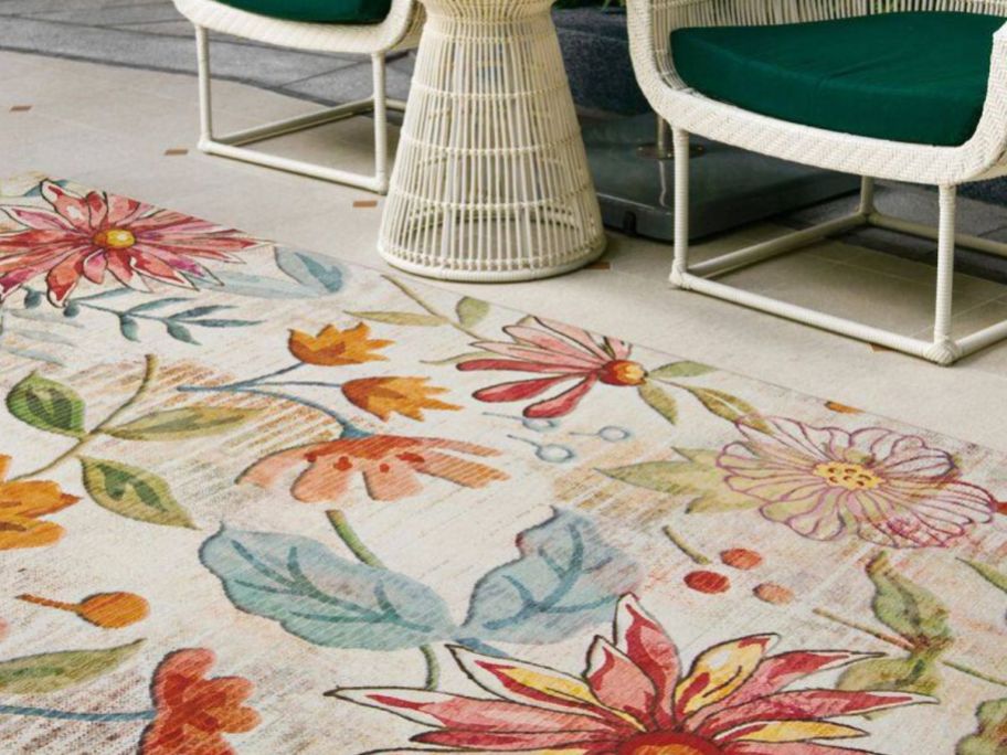floral outdoor rug with chairs in the background
