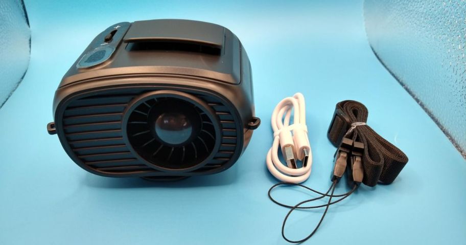 A portable waist fan with attachments on a blue box