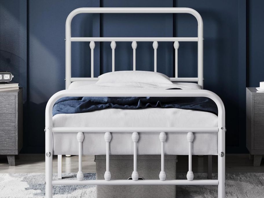 white twin-size bed inside of a bedroom with