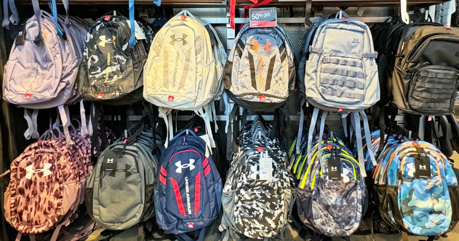 under armour backpacks on display wall in store
