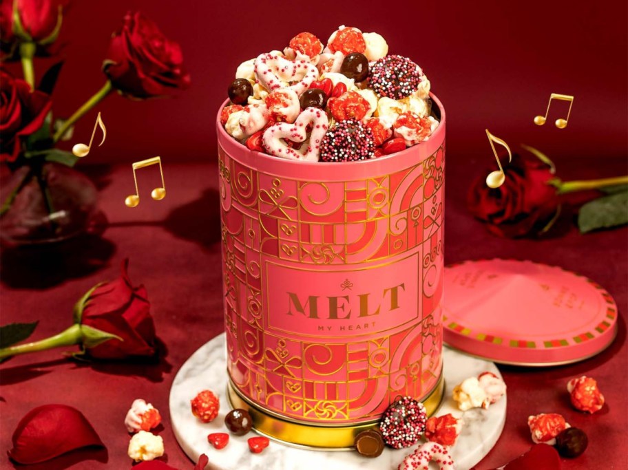 pink tin full of sweet snacks and popcorn