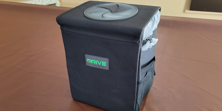black car trash can on table
