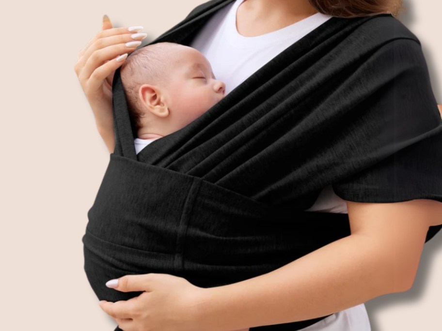 woman with a baby in a black baby wrap carrier
