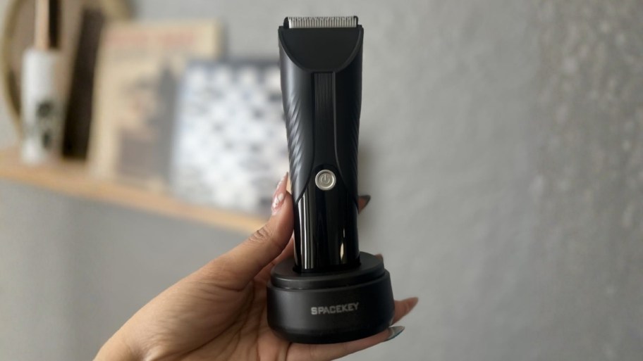 womans hand holding rechargeable electric trimmer