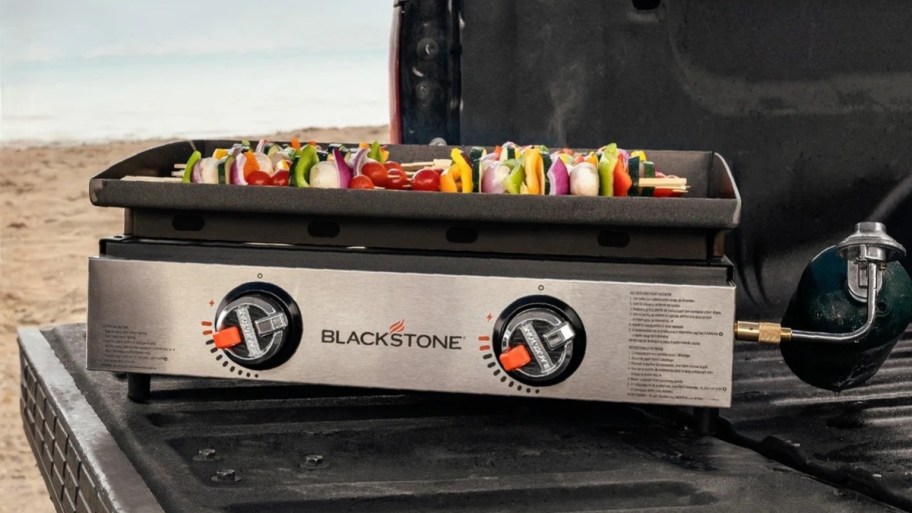 a blackstone griddle on a truck tailgate