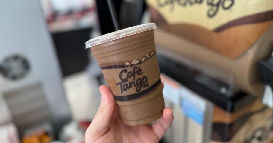Hand holding a Cafe tango Iced Coffee