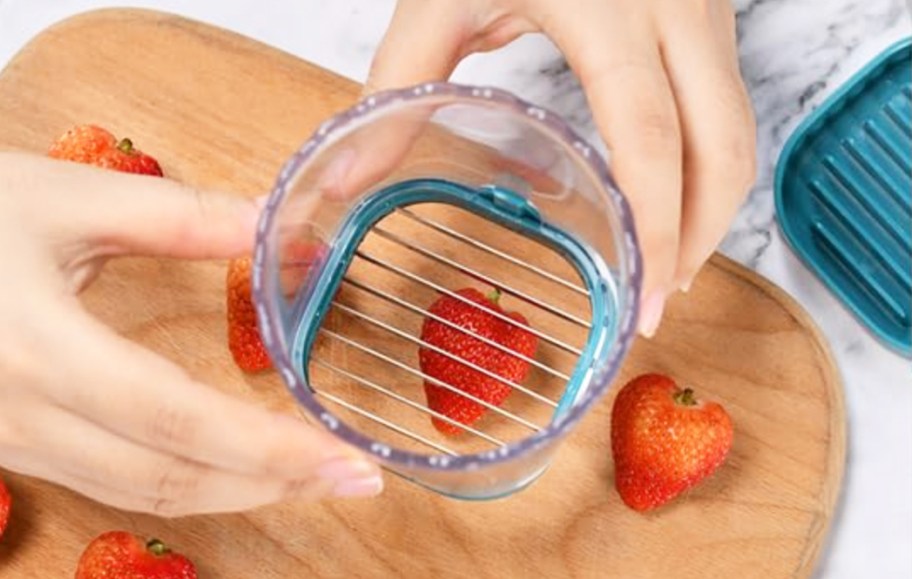 slicing a strawberry with a fruit slicing cup
