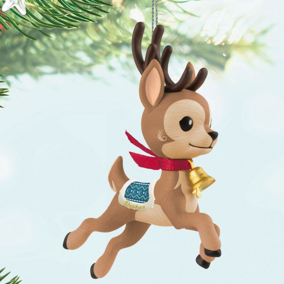 stock image of Hallmark Eight Tiny Reindeer Dasher Ornament dangling from a Christmas tree