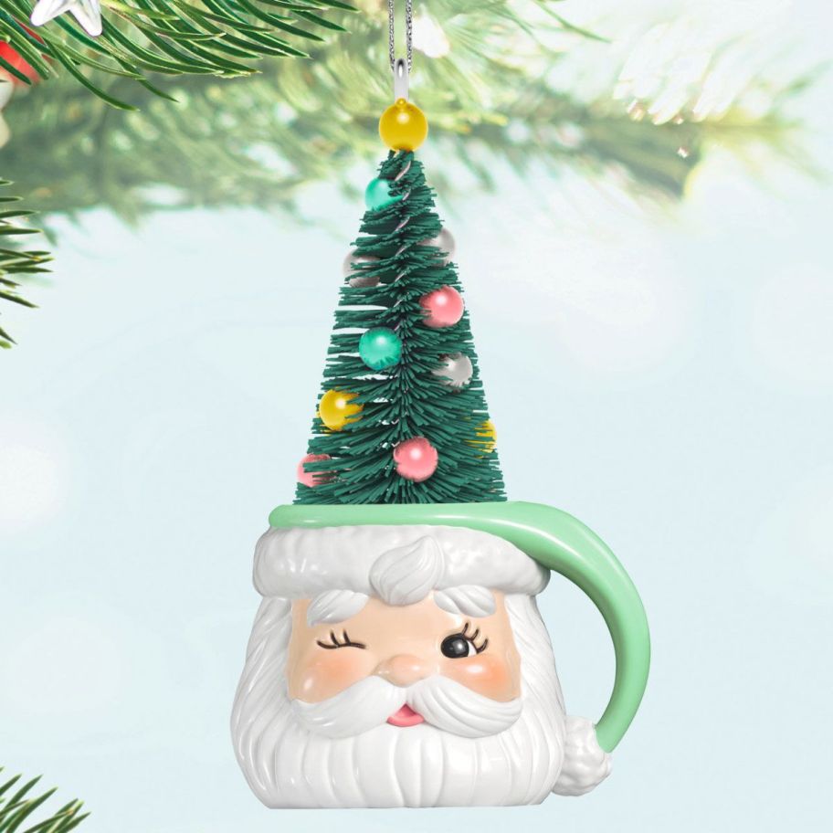 stock image of Hallmark Jolly Old Elf Ornament dangling ona. Christmas tree