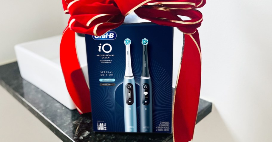 electric toothbrush set with red bow on top on a bathroom counter