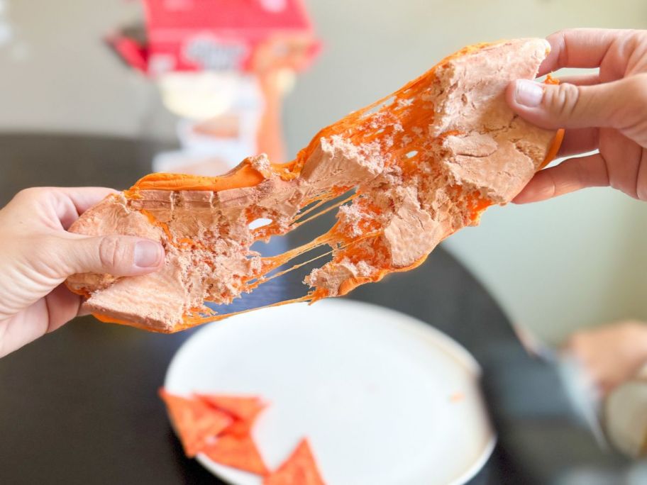 Hands pulling apart a Slime Life Grilled Cheese