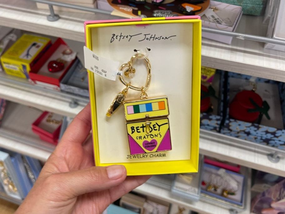 A bag charm in the shape of a crayon box