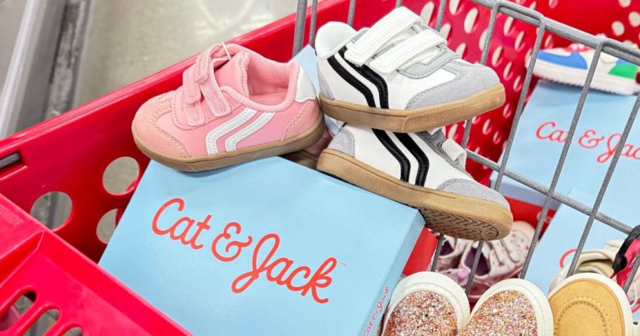 A Target shopping cart filled with kids shoes and Cat & Jack shoe boxes