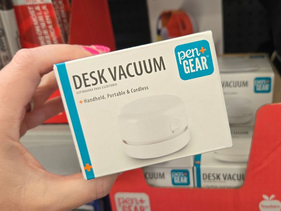 Hand holding a Pen+Gear Compact Desk Vacuum
