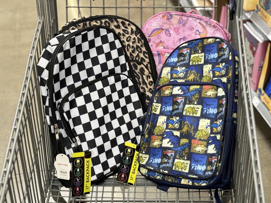 backpacks in checkered, leopard, unicorn, and dinosaur prints in a shopping cart