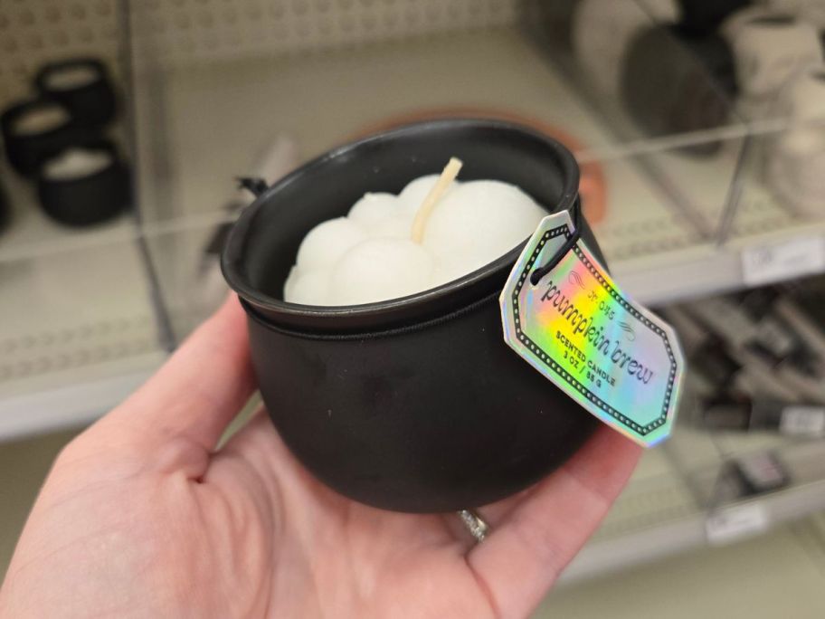 Pumpkin Brew Candle in hand in store