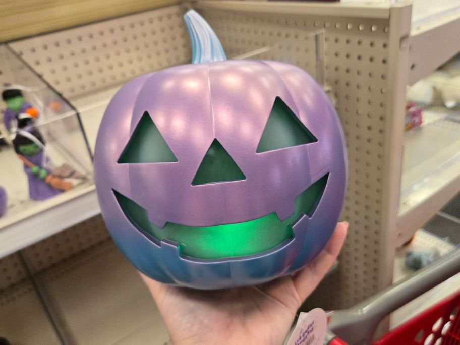 purple pumpkin led figure in hand in store