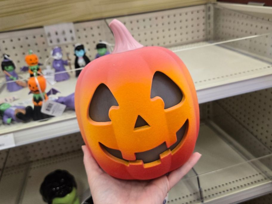 orange pumpkin led figure in hand in store