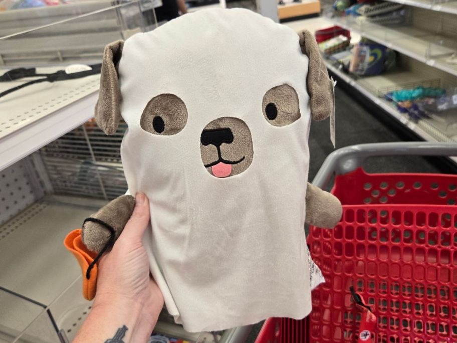 dog ghost plush in hand in store